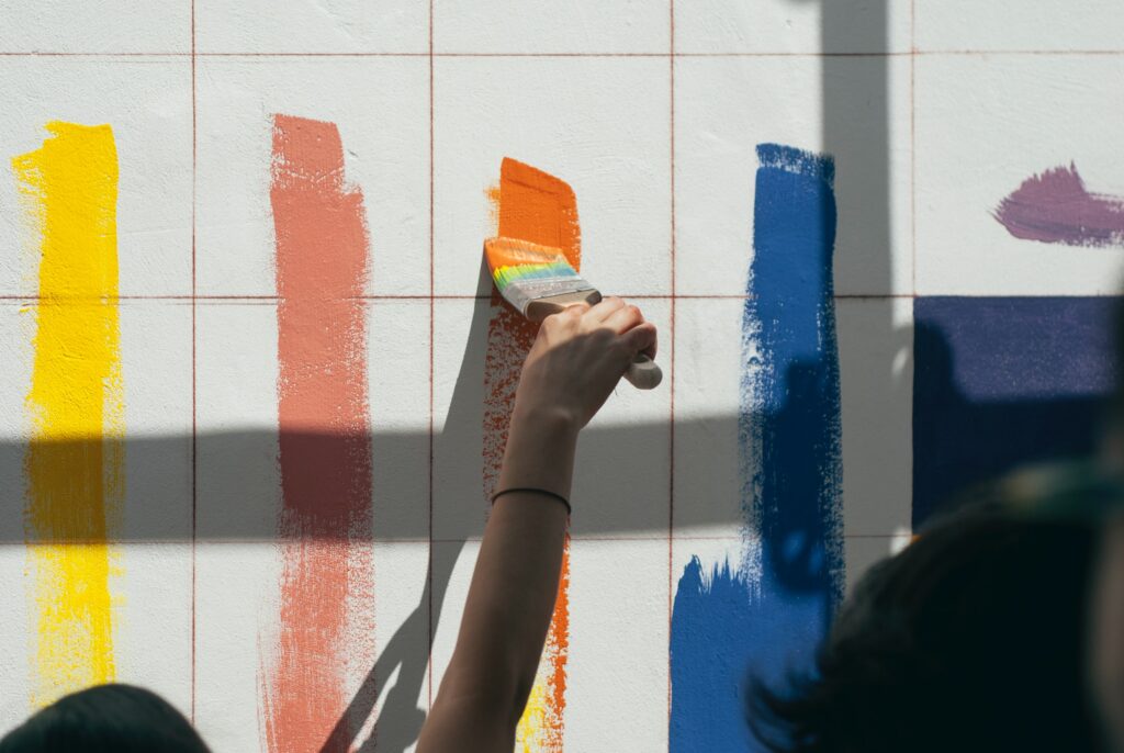 Several paints being tested on a wall